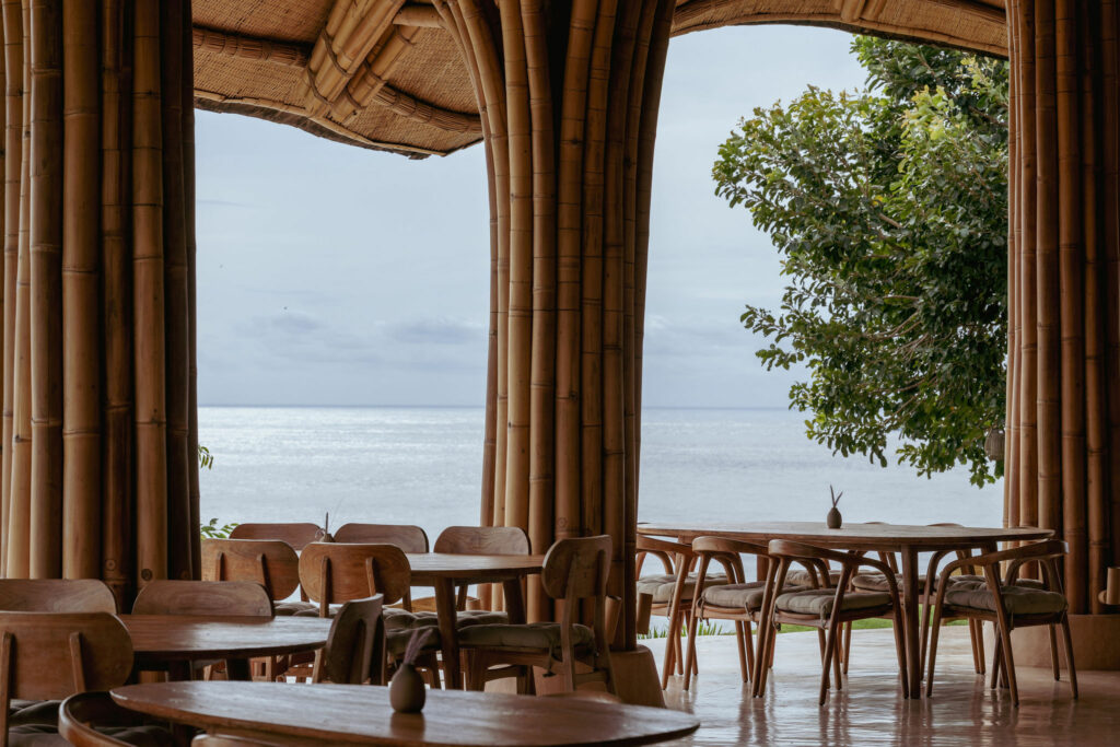 Open-air dining area with ocean views at a luxury retreat in Bali.