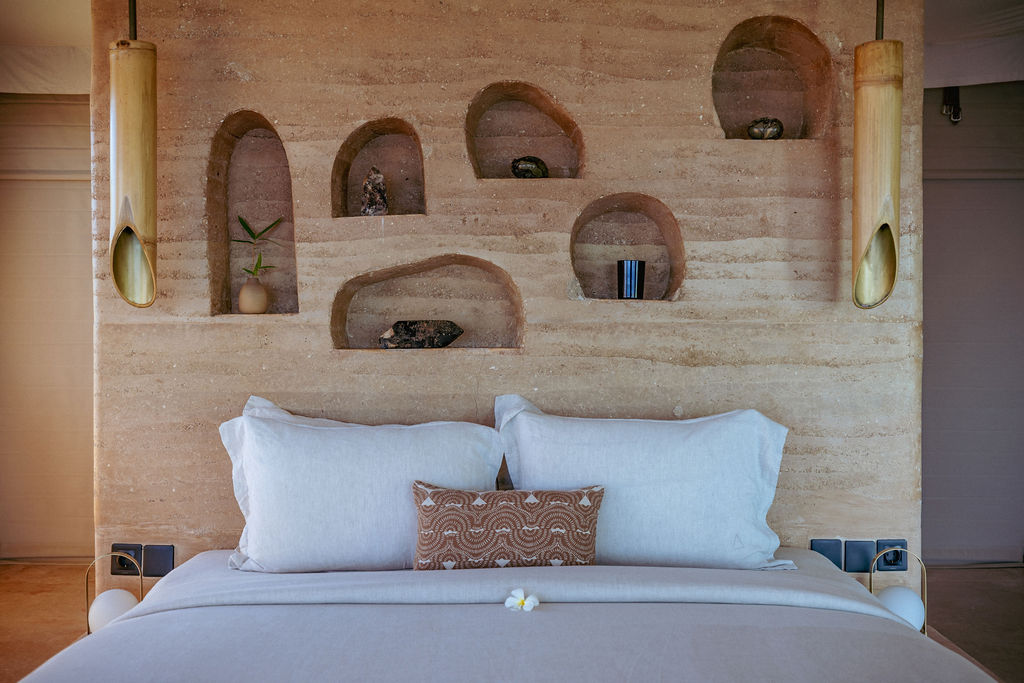 Carved bamboo headboard detail in a luxury tent suite in Bali.