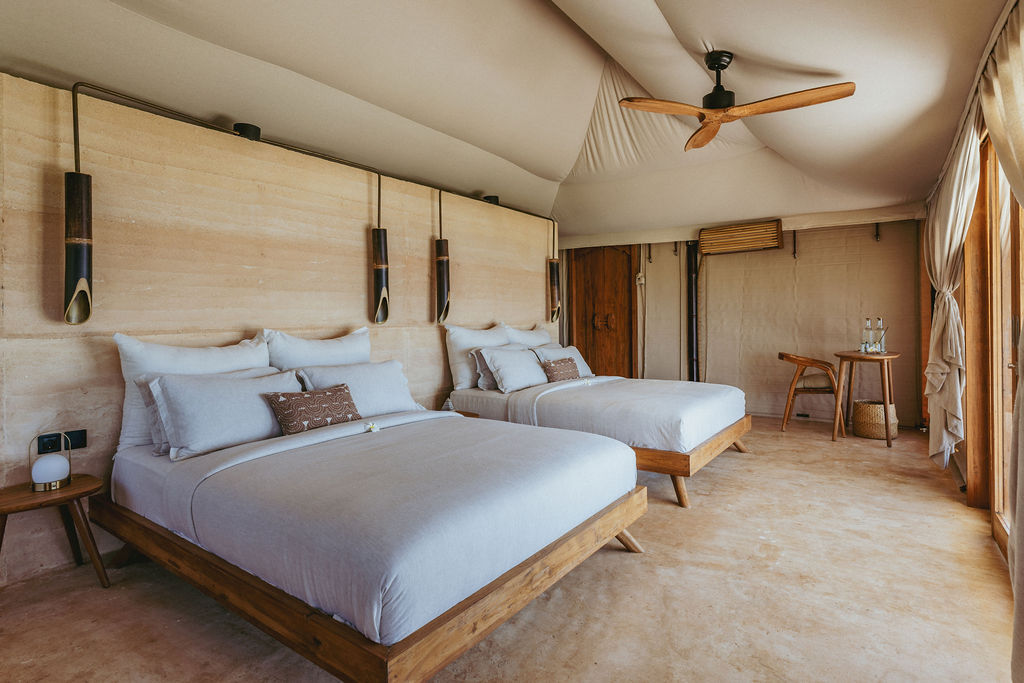 Two queen bed inside a luxury tent suite in Bali.