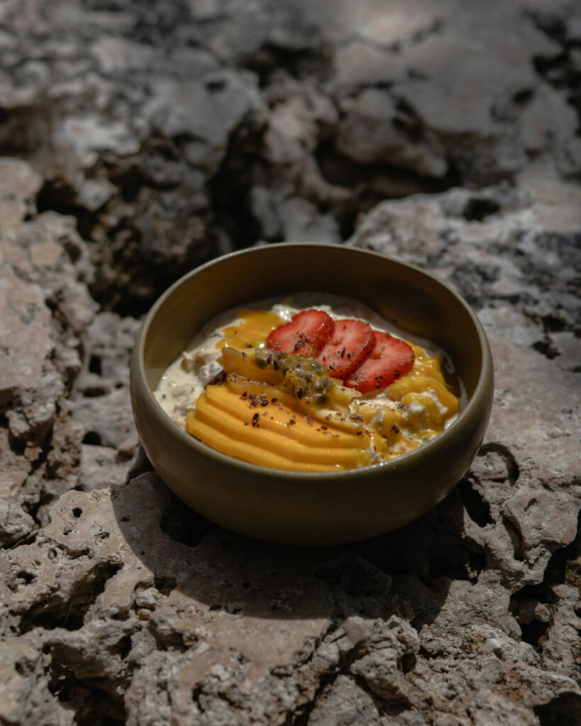 Farm-to-table dish served in a bowl on natural rock in Bali.